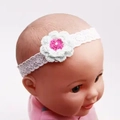 Elegant white lace baby headband featuring handmade crochet flower with pink center detail - Knitted Green Flower