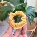 Elegant yellow fabric scrunchie with ruffle edge texture held in hand for hair styling - Bright Yellow