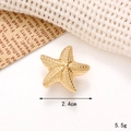 Detailed close-up of golden starfish charm for clogs with metallic texture and 2.4cm size - C253 Gold Starfish