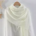 Wrinkled cotton linen scarf in ivory white with fringe edges worn on a shirt - Off White
