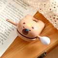 Cartoon brown bear keychain toy in smooth plastic finish on a rustic wooden desk - Tan Ornament Sleepy