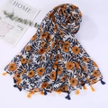 Close-up of orange floral print and colorful tassels on a cotton linen beach shawl scarf - Style 20