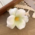Elegant white tulip hair clip with realistic petals and yellow stamen on wood surface - White Green Gradient