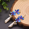 Baroque pearl earrings with blue enamel flower and gold metal on a wooden tray - Baroque Flower Dangle