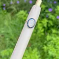 18K gold plated ring featuring Virgin Mary cameo with blue zircon halo on green grass - Blue