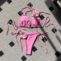 Pink bikini set featuring 3D rose flower accents and adjustable lace-up ties - Pink