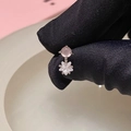 Elegant silver earrings with pink bead and clear flower pendant held in hand - Star Cat's Eye