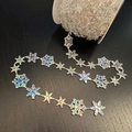 Iridescent snowflake garland on white spool with laser rainbow effect on dark wood - 10m / Iridescent Snowflake