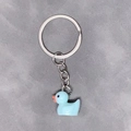 Minimalist light blue resin duck keychain with silver ring on a neutral background - 28mm Ring / Blue