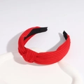 Bright red knotted knit headband for women featuring ribbed fabric texture and comfort tips - True Red