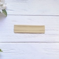 Elastic khaki yoga headband with soft knit texture on a wooden background - Beige