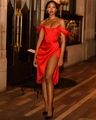 Detailed view of red satin off-shoulder dress with high slit and slim fit evening style - XS / Red