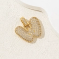 Golden chubby letter W pendant with clear zircons on a beige textured background - Letter W