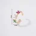 Detail view of a gold butterfly ring featuring pink, white, and emerald green zircons - Three-Color Butterfly Colored Gemstone Open Ring(R00414-1)