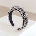 Padded wide headband featuring assorted silver metallic pearls on a black base - Silver