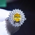 Macro shot of a platinum plated ring with a large oval yellow gemstone and halo diamonds - Adjustable Open / No.3-Oval Yellow Stone