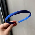 Minimalist dark blue satin headband with a smooth matte texture held in hand - Royal Blue