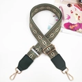Close-up of geometric pattern strap with green PU leather and gold metal hooks - Green Khaki + Green Leather