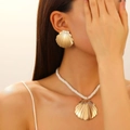 Exaggerated golden shell earring and necklace set with white woven rope on model - Gold Shell Shape Accessory Set (K-066+K-067)