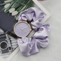 Detail of lavender silk ribbon scrunchie watch strap with golden round case and dial - Purple