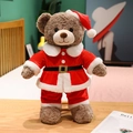 Brown teddy bear plush in a Santa Claus outfit with a red hat and belt on a bed - 48cm / Camel