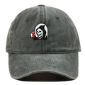 Close-up of embroidered skull reaper patch on a vintage washed grey cotton baseball cap - Army Green
