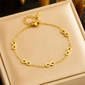 Gold-plated stainless steel chain bracelet with infinity charms on a jewelry cushion - Infinity Bracelet (B1380) / Gold