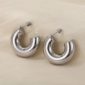 Polished silver stainless steel thick C-shaped hoop earrings on elegant silk background - Silver Smooth Style