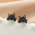 Close-up of minimalist black cat stud earrings on a textured white ceramic display stand - 749 Black
