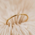 Close-up detail of minimalist gold titanium steel ring with three small crystals - US 5 / Gold (3-Diamonds)
