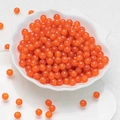 Translucent bright orange 6mm round glass beads for DIY jewelry making in a shell dish - Deep Orange Chalcedony Beads (6mm)
