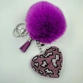 Close-up of leopard heart pendant with purple faux fur pompom and stylish tassel charm - Purple