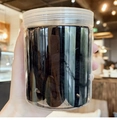 Detail of multi-pack high-elastic black seamless hair ties in a clear cylindrical jar - Black