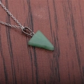 Green triangular stone pendant necklace with silver metal chain on wood background - Green Aventurine Triangle