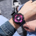 Macro detail of waterproof black and pink dual-display sports watch on a male wrist - Black Pink