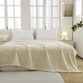 Creamy beige flannel blanket featuring embossed butterfly pattern on a cozy modern bed - Off-white