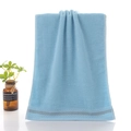 Soft light blue cotton towel featuring elegant honeycomb texture and grey stripe details - Youth Blue
