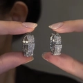Elegant silver leaf hoop earrings with brilliant zircon stones held by a person - R0868 Bamboo Hoop Earrings / Silver