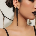 Luxurious long black tassel earrings featuring shimmering rhinestones on female model - Black