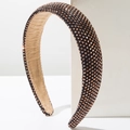 Macro detail of dense rhinestone inlay on a thick headband with soft velvet inner lining - Coffee