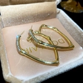 Detailed view of golden heart-shaped bamboo texture earrings with sparkling crystals - Gold (Silver Earring Post)