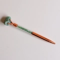 Detailed macro view of rose gold ballpoint pen with green raw stone and crystal chips - Aventurine Jade