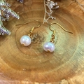 Close-up of natural white freshwater pearl earrings with golden hooks on wooden background - Double Pearl Drop Earrings