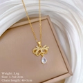 Macro shot of gold butterfly necklace pendant with crystal drop and size specifications - Titanium Steel Chain Copper Pendant / Bowknot Water Drop Necklace (D539)