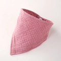 Close-up of pink muslin cotton baby bib showing soft textured fabric and snap button - Deep Pink