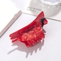 Detail of red cardinal bird hair claw clip made of acetate with glossy finish - Cockatoo