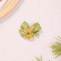 Detail of green burlap Christmas bow featuring gold bells and Merry Christmas print - Green with Gold Leaves