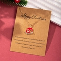 Detailed view of Christmas hat pendant on gold chain with Merry Christmas gift card - Christmas Hat