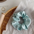 Sky blue crystal satin scrunchie with silk texture on white paper background - Apple Green