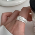 Minimalist silver ring with ripple texture on woman's finger showing elegant design - JZ0049-Ripple Design